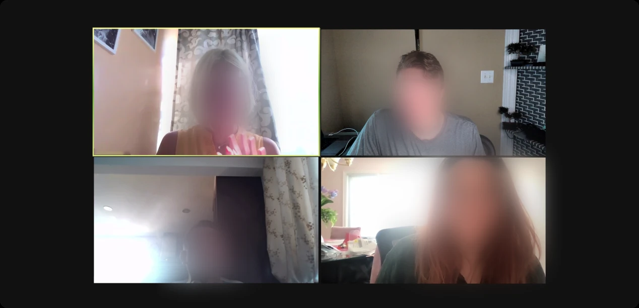 A four-person video call, faces blurred.