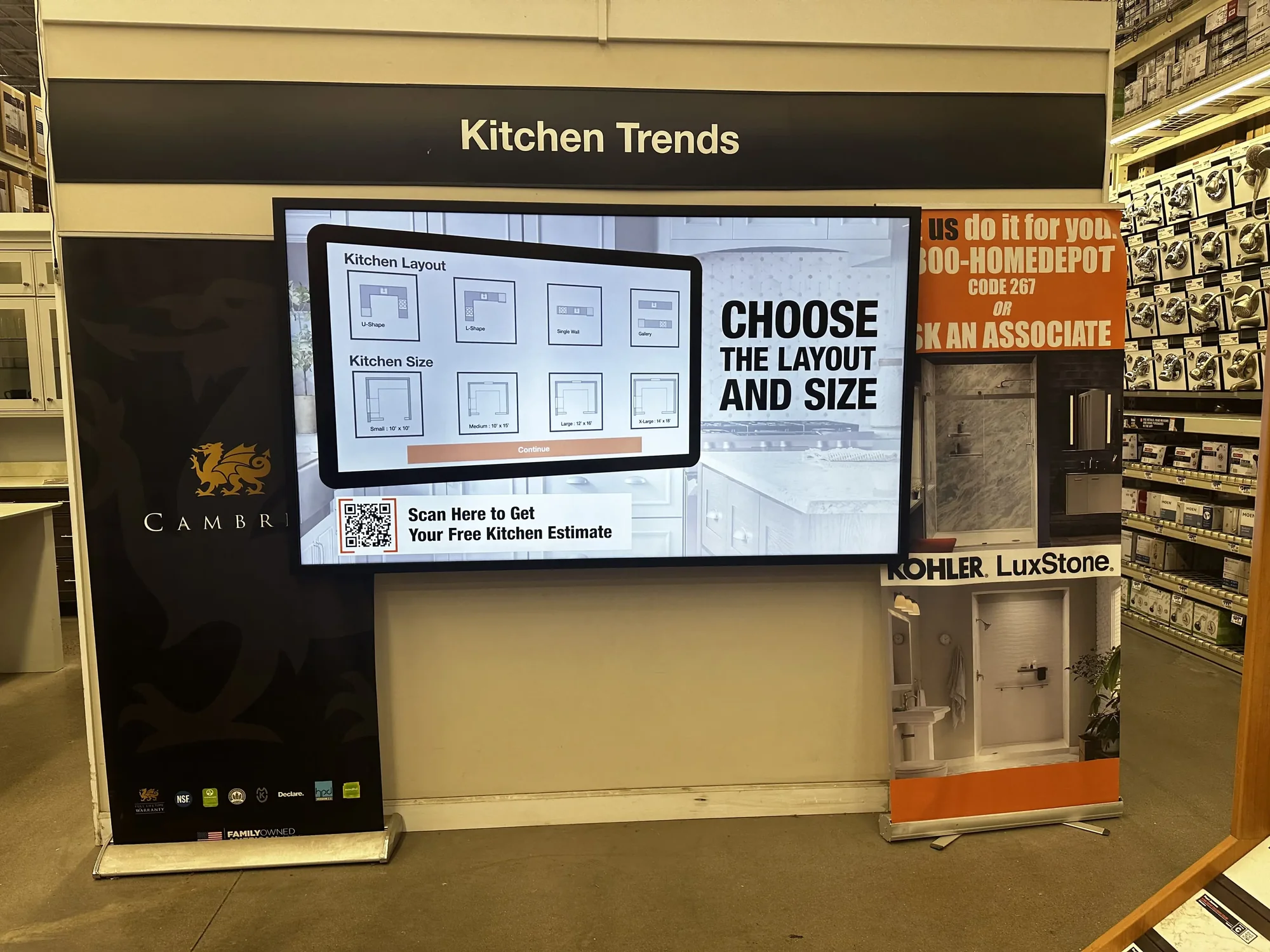 A Home Depot in-store kitchen display offering a code to scan for a free kitchen estimate